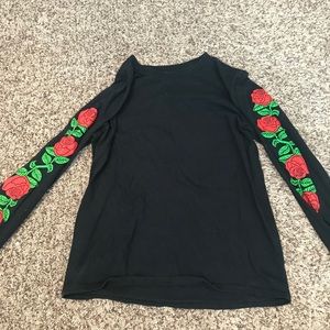 black shirt with roses on sleeves